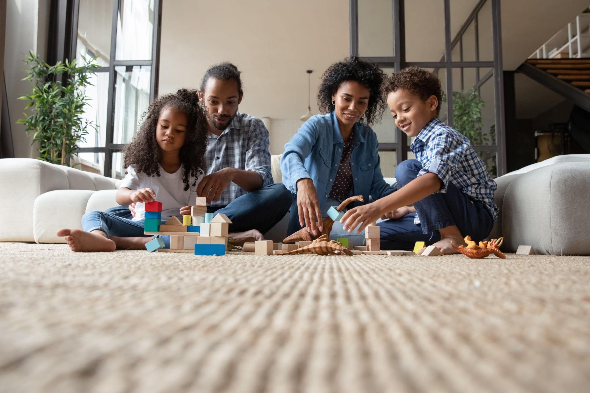 Family and pets relaxing on clean dry carpet after fast-dry carpet cleaning in Boise home
