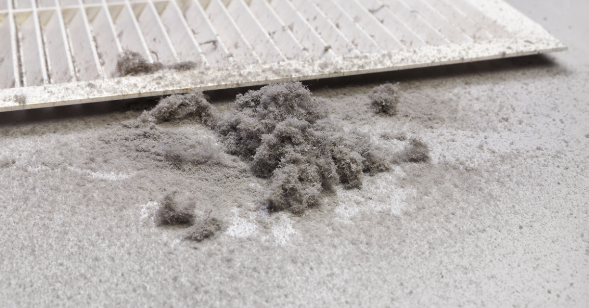 dirty air duct vent register showing dust and debris buildup