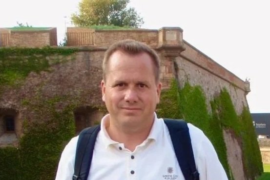 Bob Barnhart standing in front of a castle.