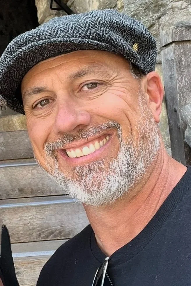 Dave Thibodeau wearing a hat in front of his deck.