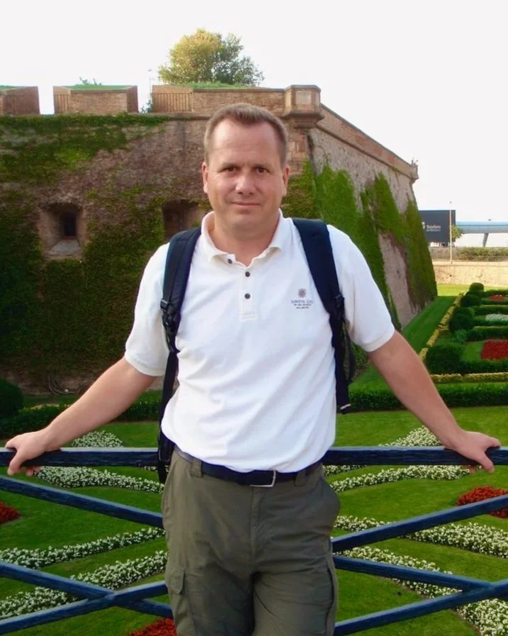Bob Barnhart standing in front of a castle.