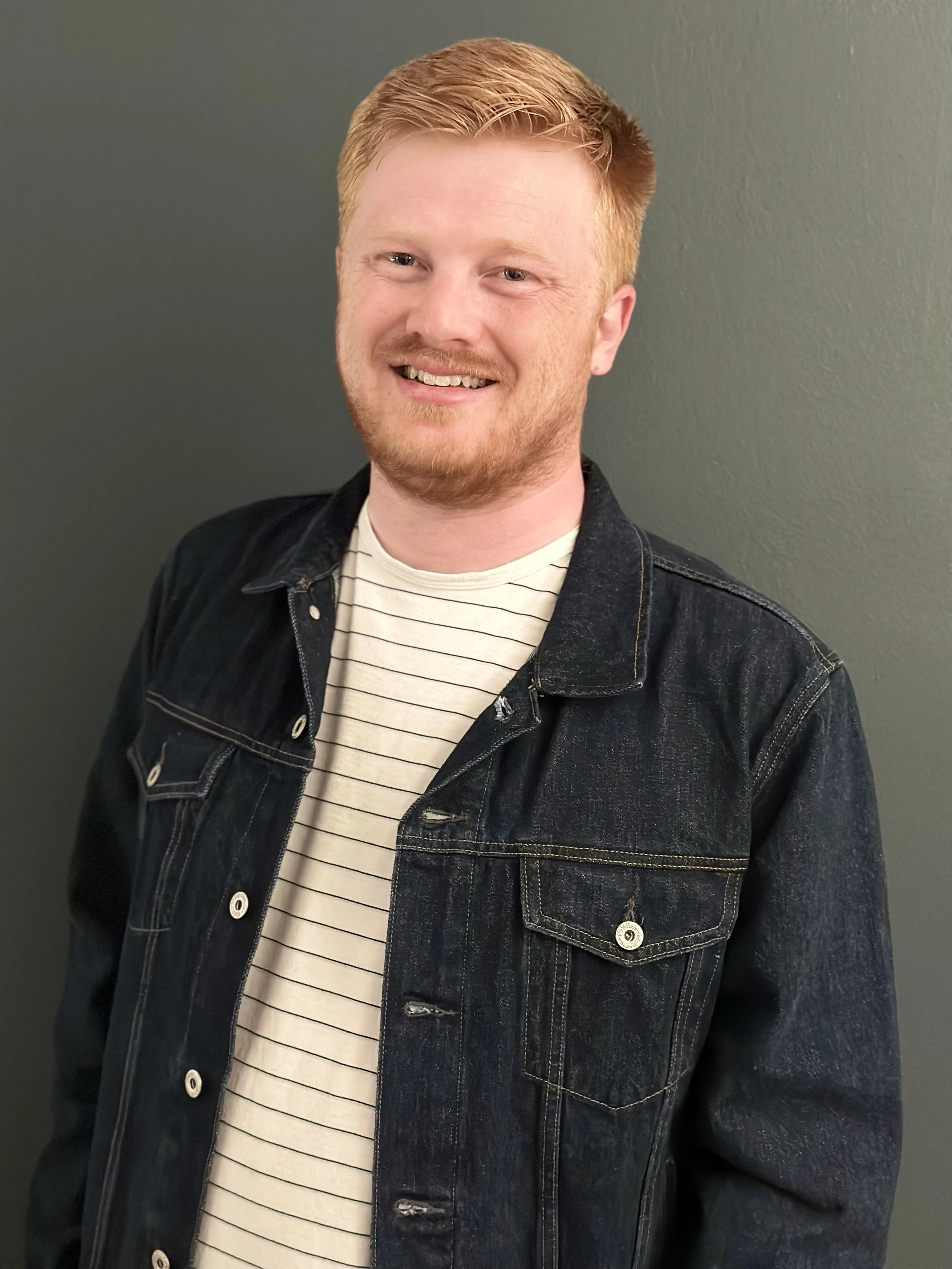 Jeff Behm standing in front of a Gray backdrop.