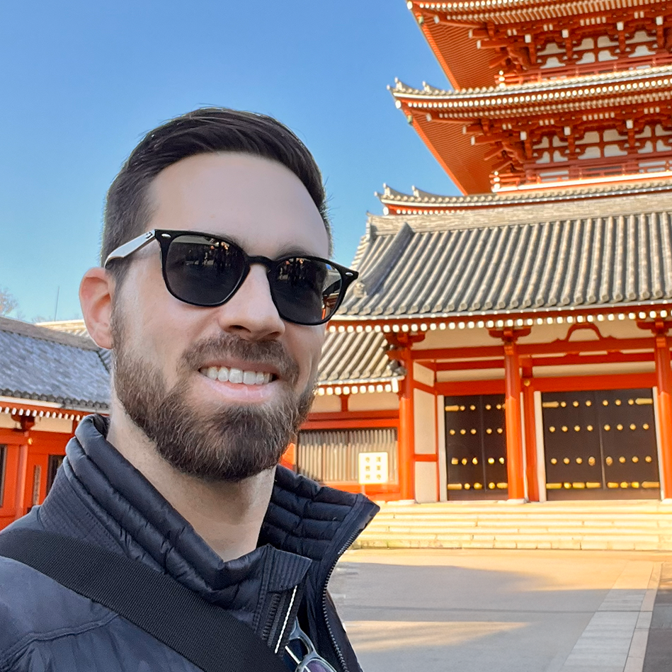 Will Gossett standing in front of a Pagoda.