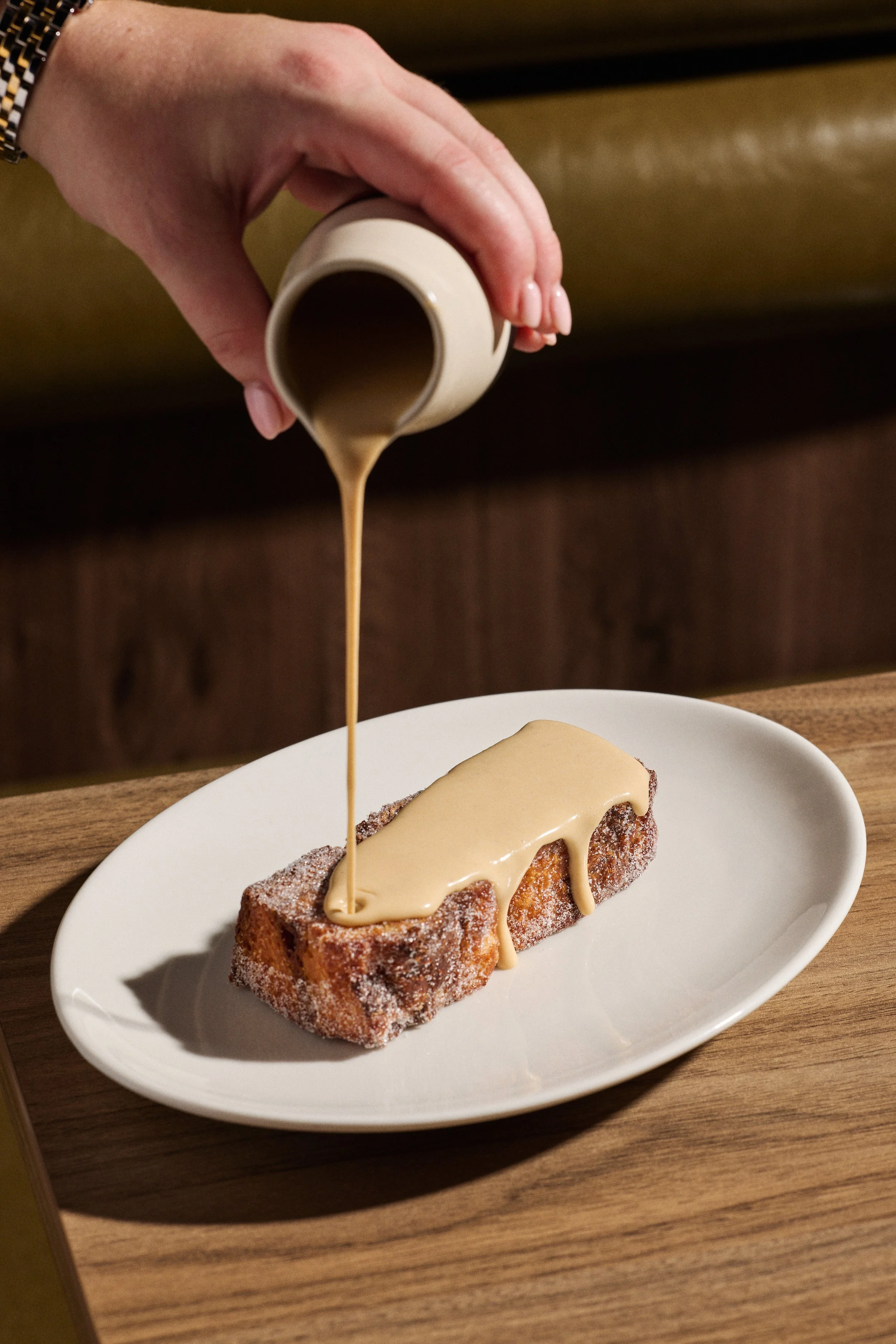 Monal Dining Bread and Butter Pudding with Brown Sugar Custard being poured on top