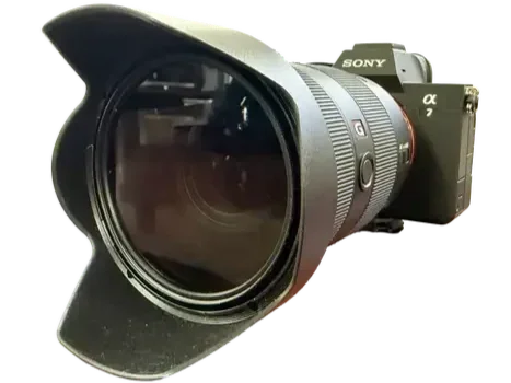 Camera with a large lens and lens hood, branded Sony Alpha a7.