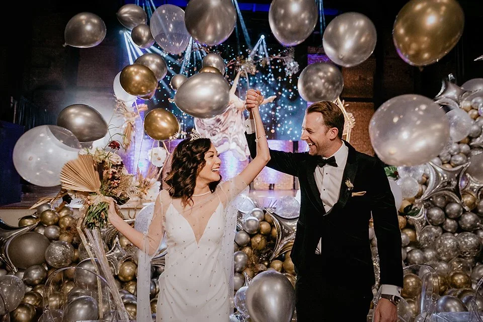 The-Yost-Theatre-bride-and-groom-with-balloons.webp
