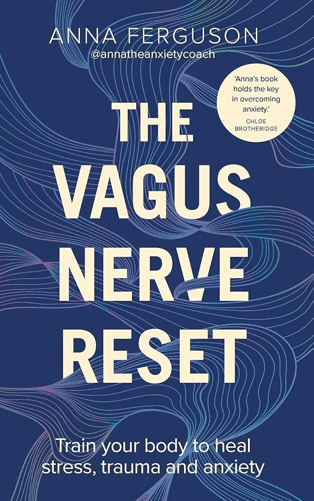 Cover page of a book titled "The Vagus Nerve Reset" by Anna Ferguson, with the handle @annathexietycoach. The subtitle reads "Train your body to heal stress, trauma and anxiety." The background features flowing, wave-like blue lines.