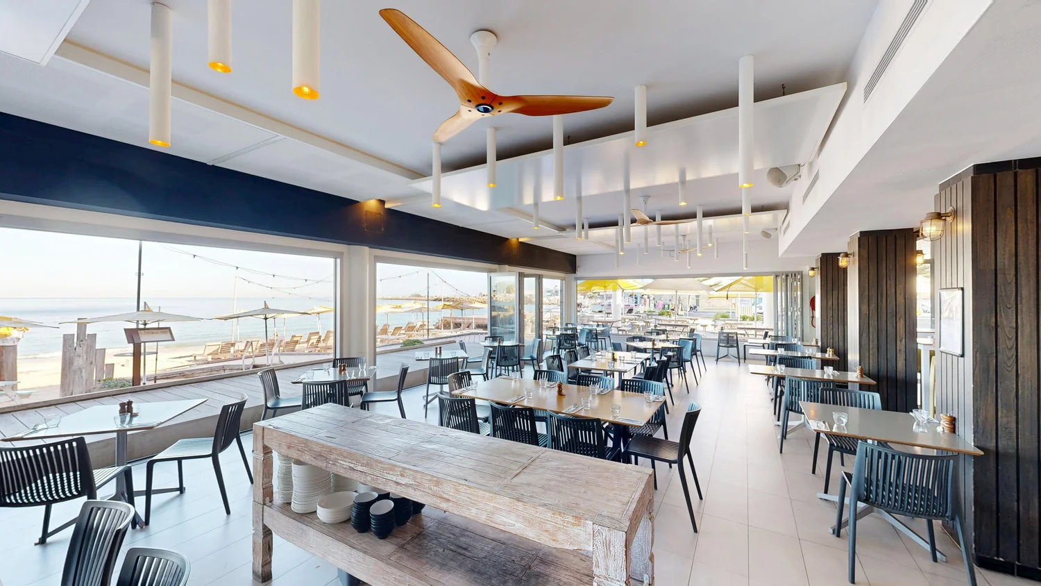 Set tables in the Bathers Beach House restaurant looking out over the beach