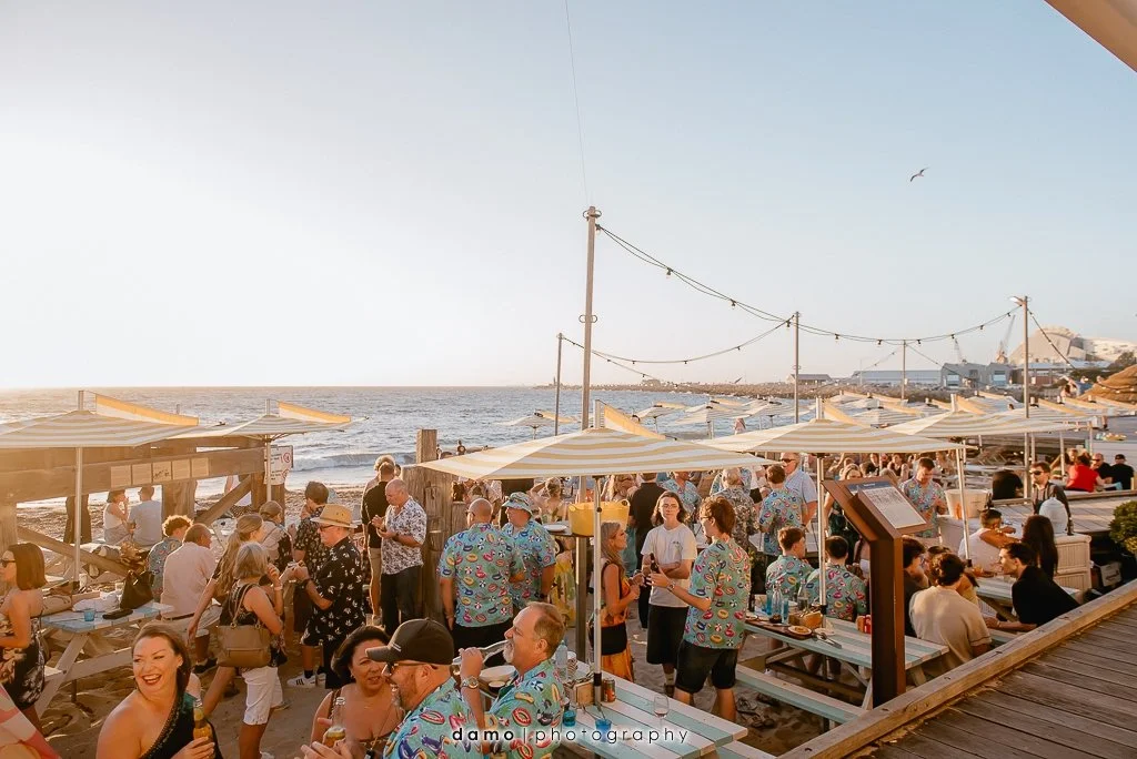 A private party on the sand in the licensed beach area at Bathers Beach House at sunset. Photo: Damo Photography