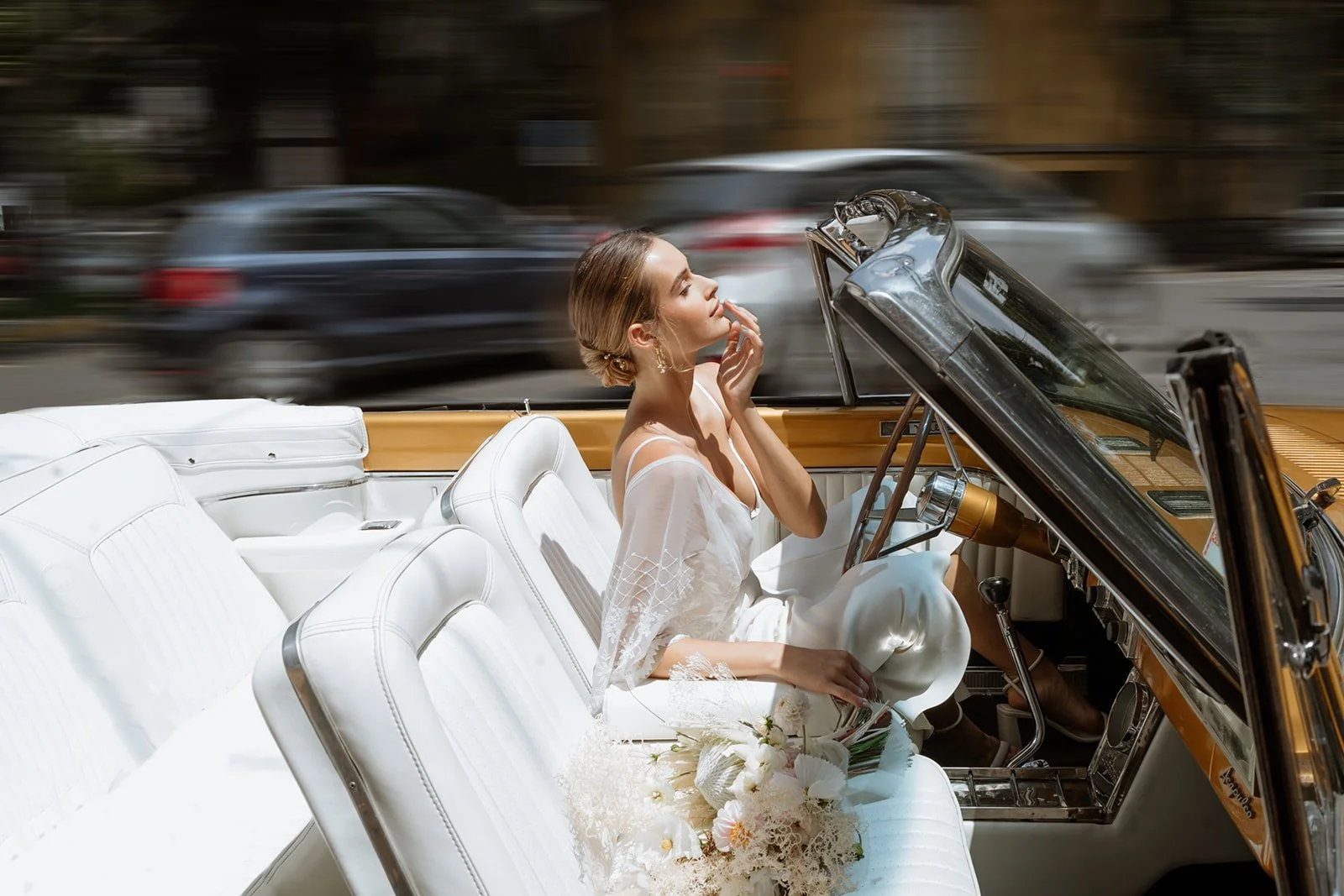editorial bridal portrait in classic car with soft light and elegant dress