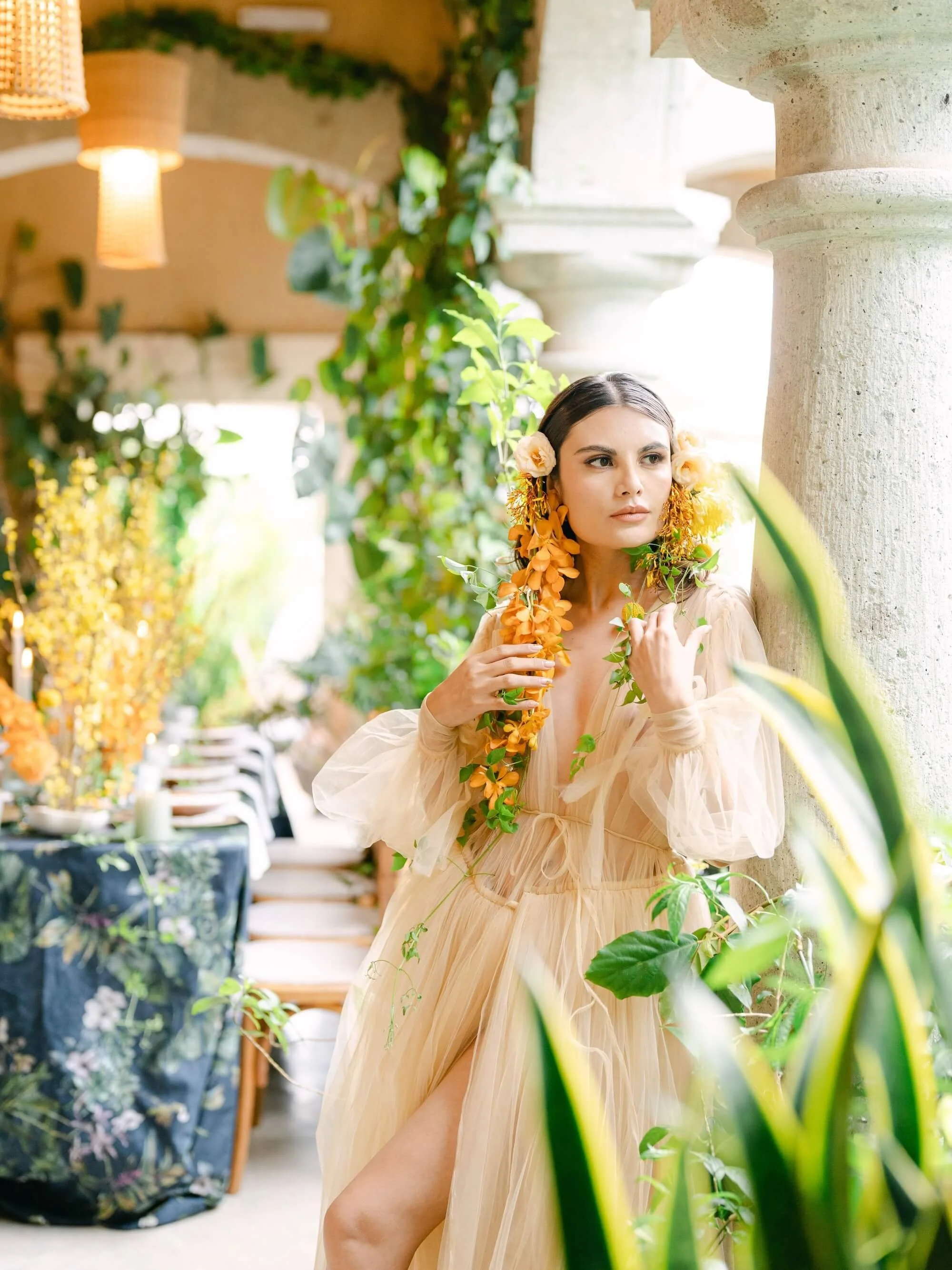 garden-inspired wedding table with vibrant yellow flowers and curated greenery decor