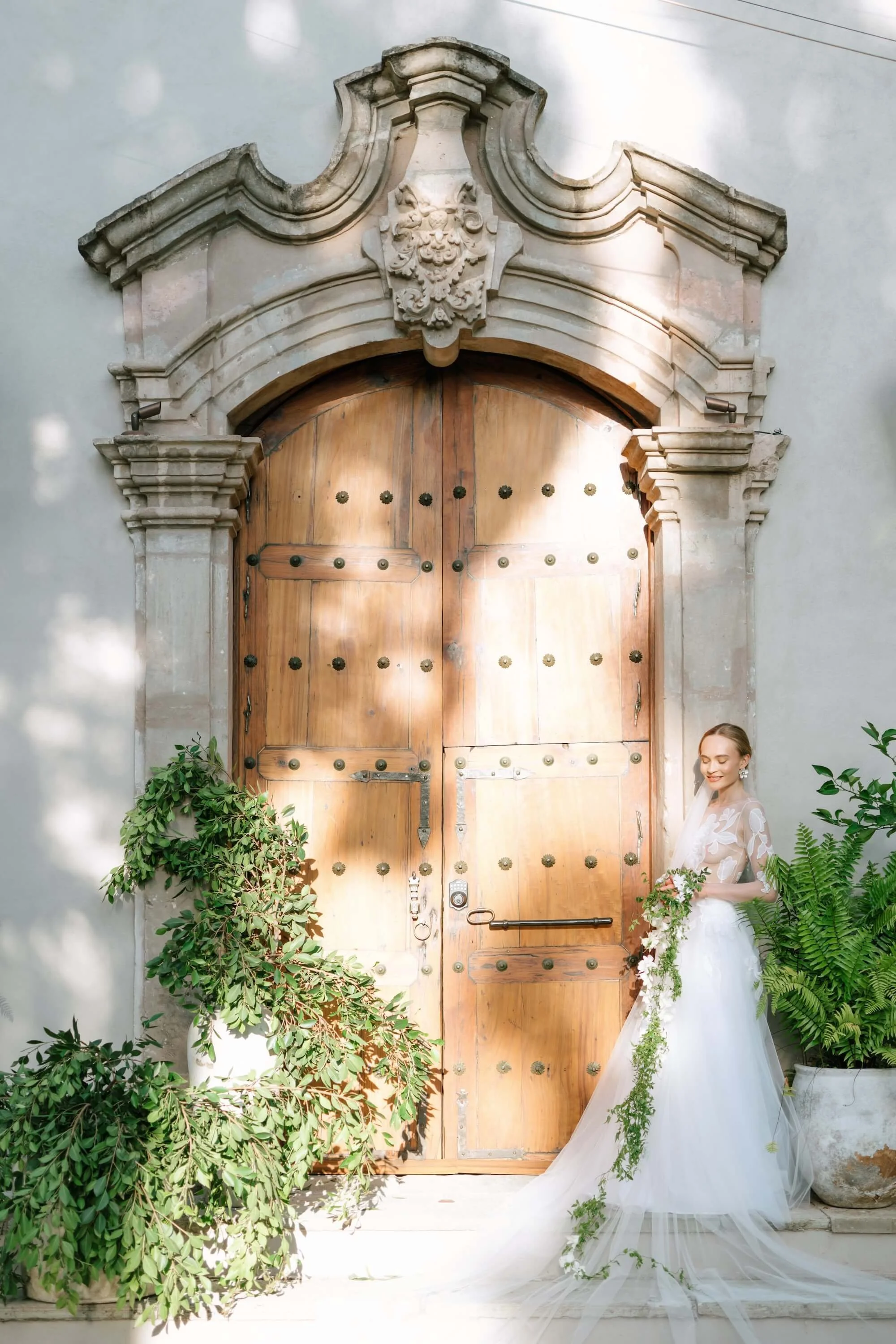 Elegant wedding table with white florals, candles and refined table setting