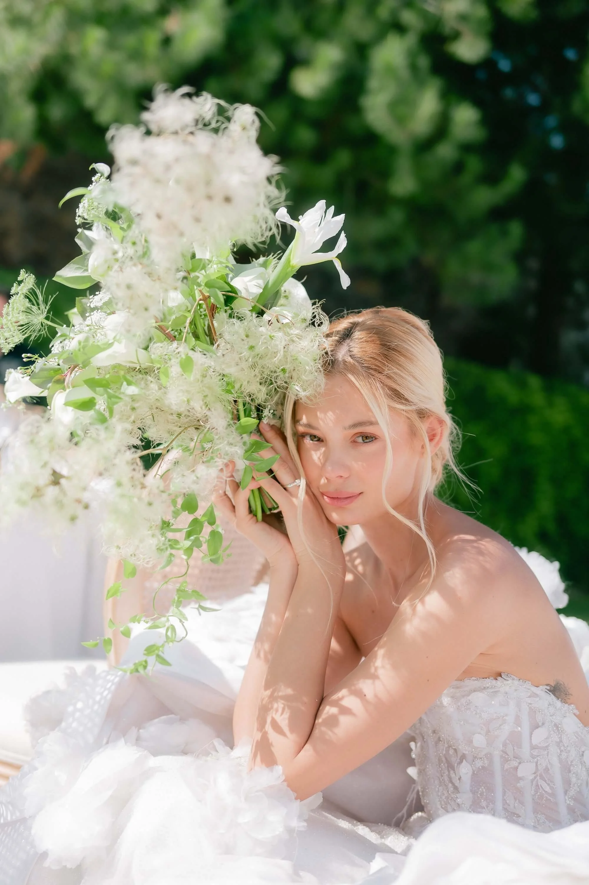 Editorial bridal moment with sculptural white floral bouquet in destination wedding setting in Mexico