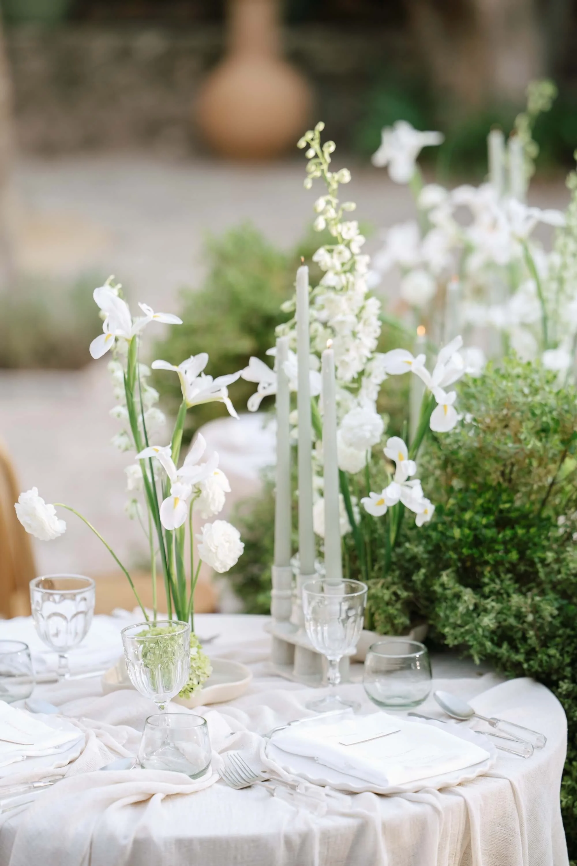 Sophisticated wedding tablescape with neutral tones and white floral arrangements
