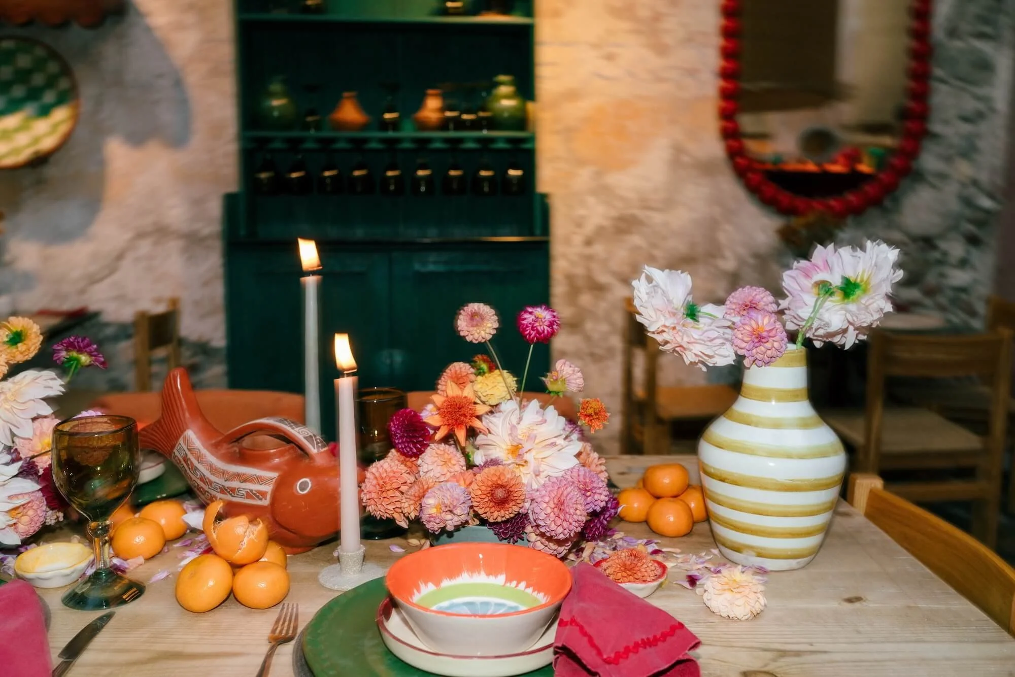 colorful reception decor with blue hydrangeas, red flowers and artisan pottery