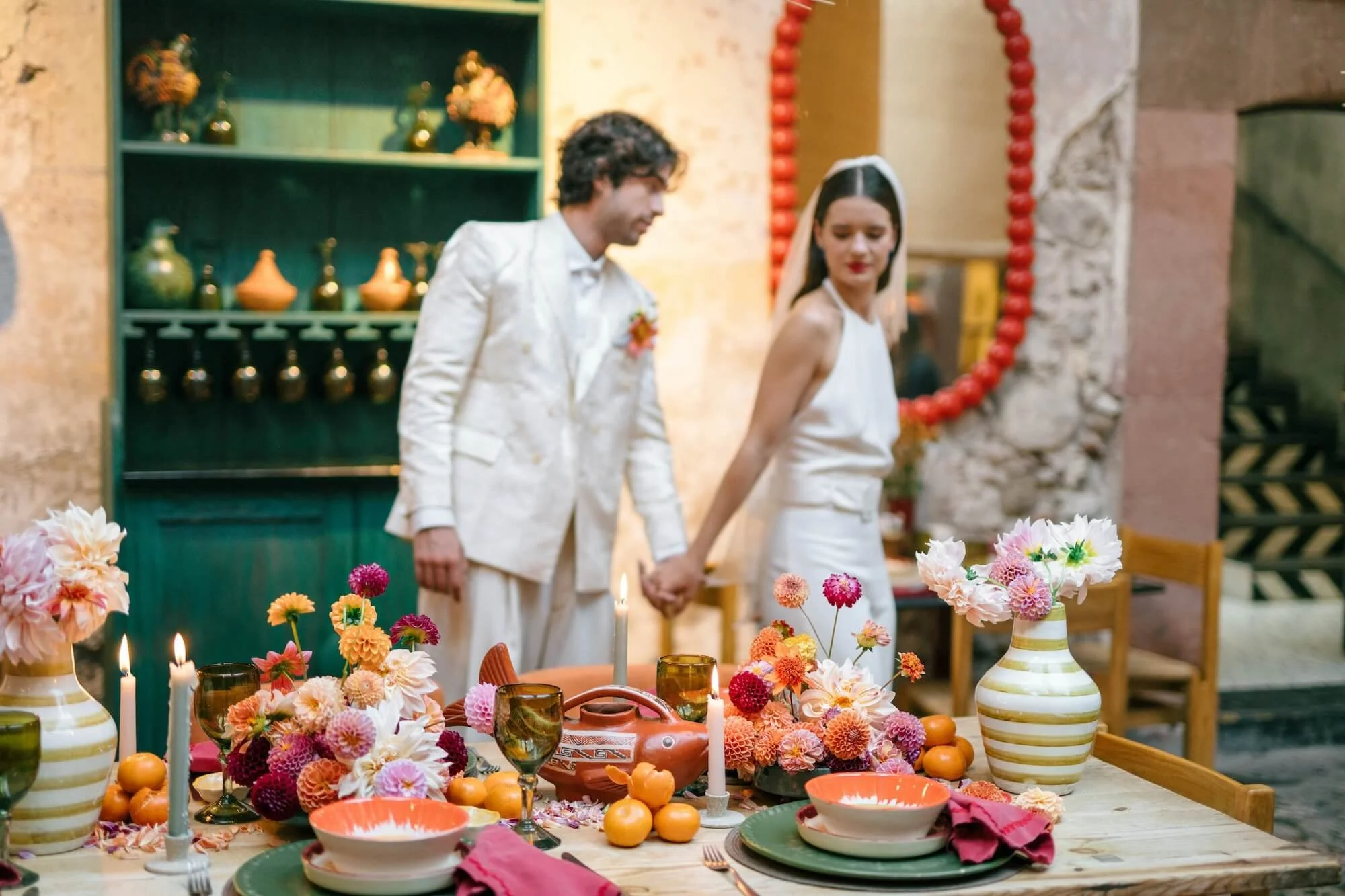 lively tablescape with warm tones and eclectic floral styling