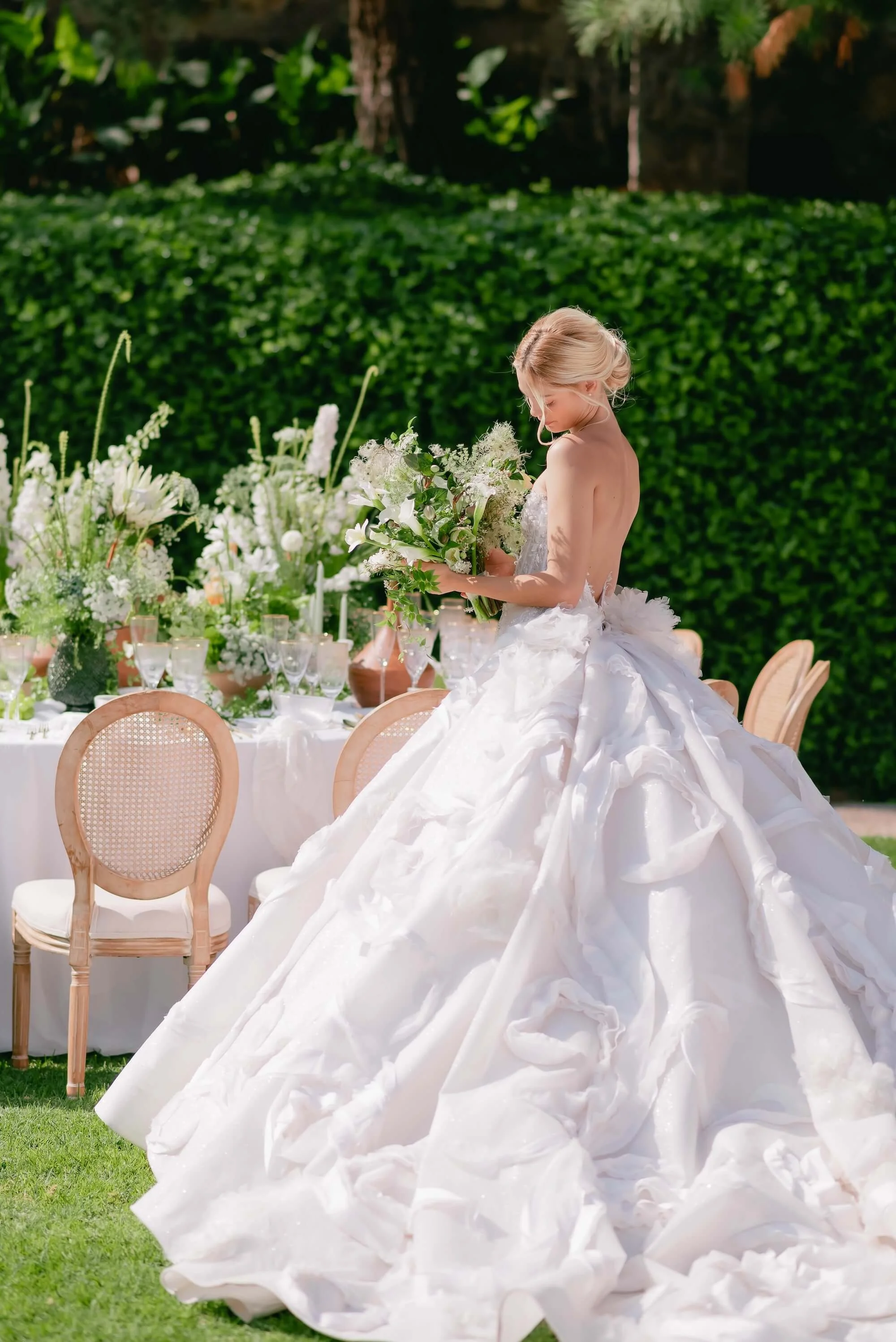 Editorial wedding moment with champagne coupe tower and refined floral accents in garden setting