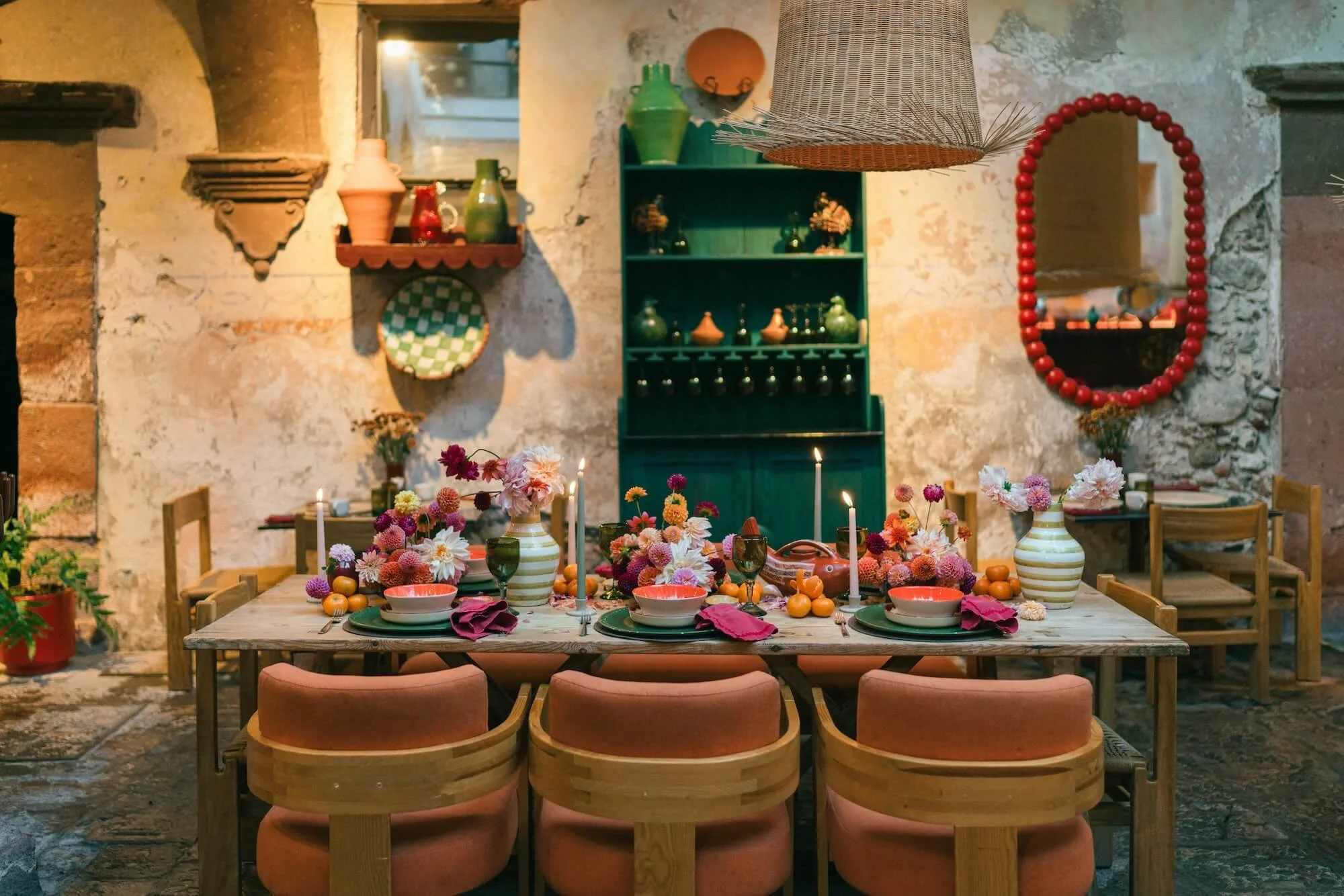 bold wedding table styling with orange, pink and red flowers and ceramic details