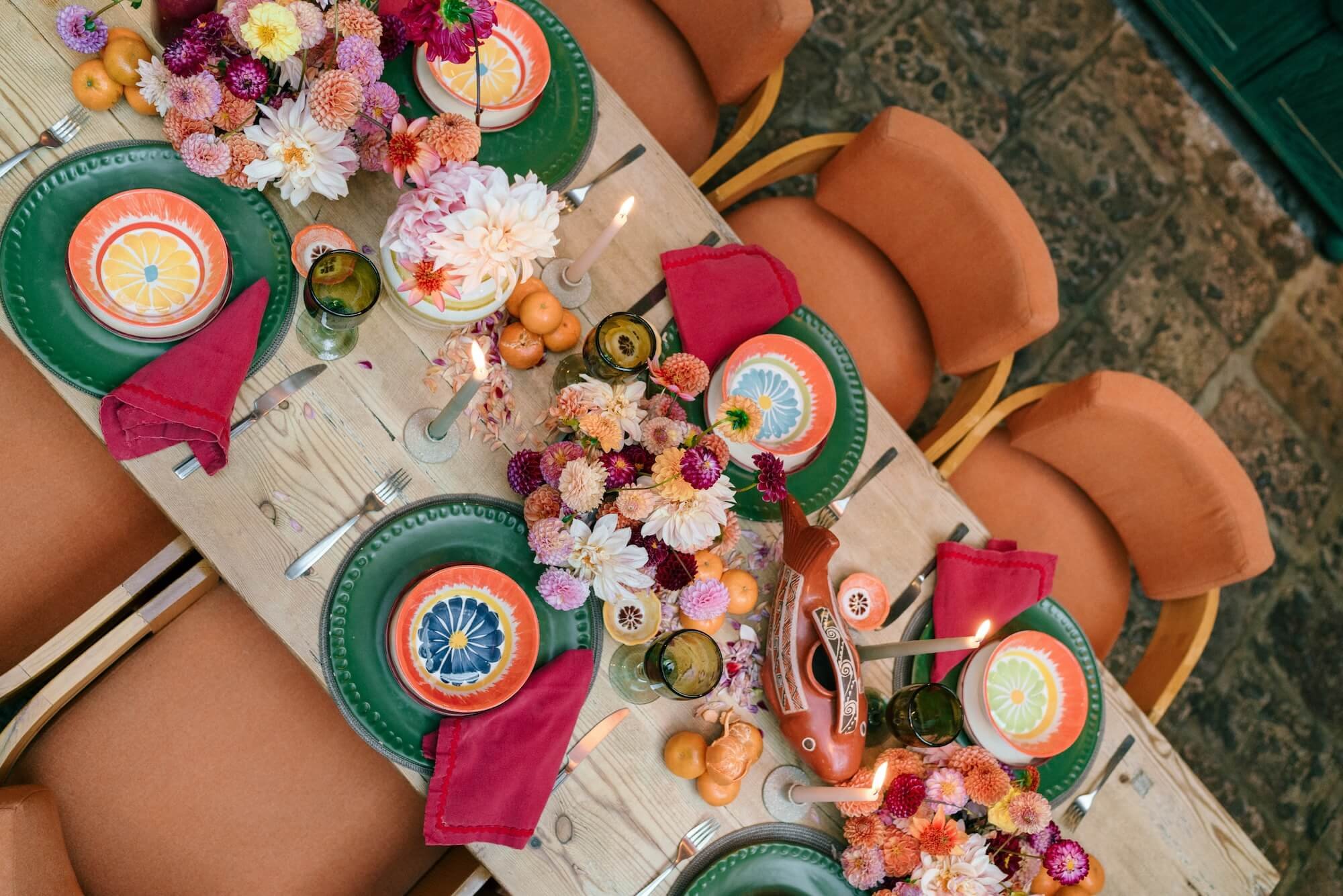 vibrant wedding table with red linens, ceramic vases and bold floral arrangements
