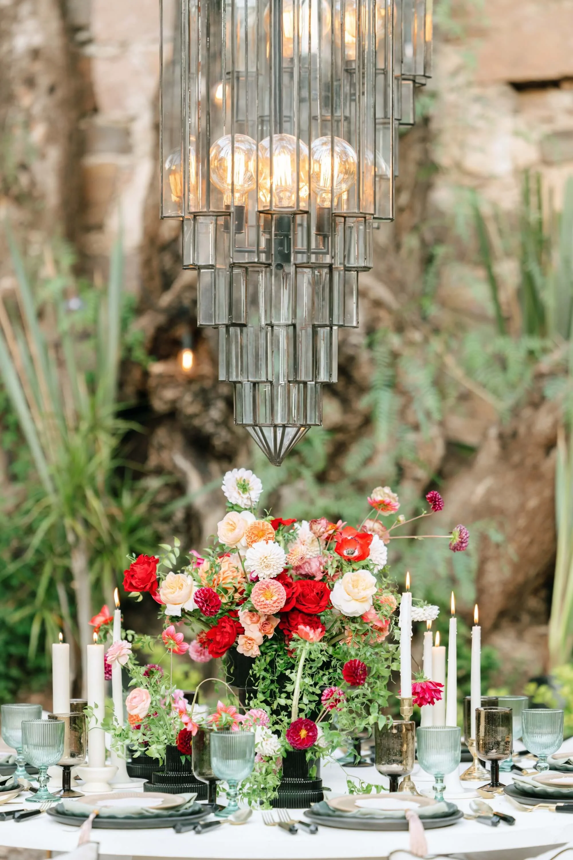 Luxury wedding decor with candles, glassware and modern floral arrangements