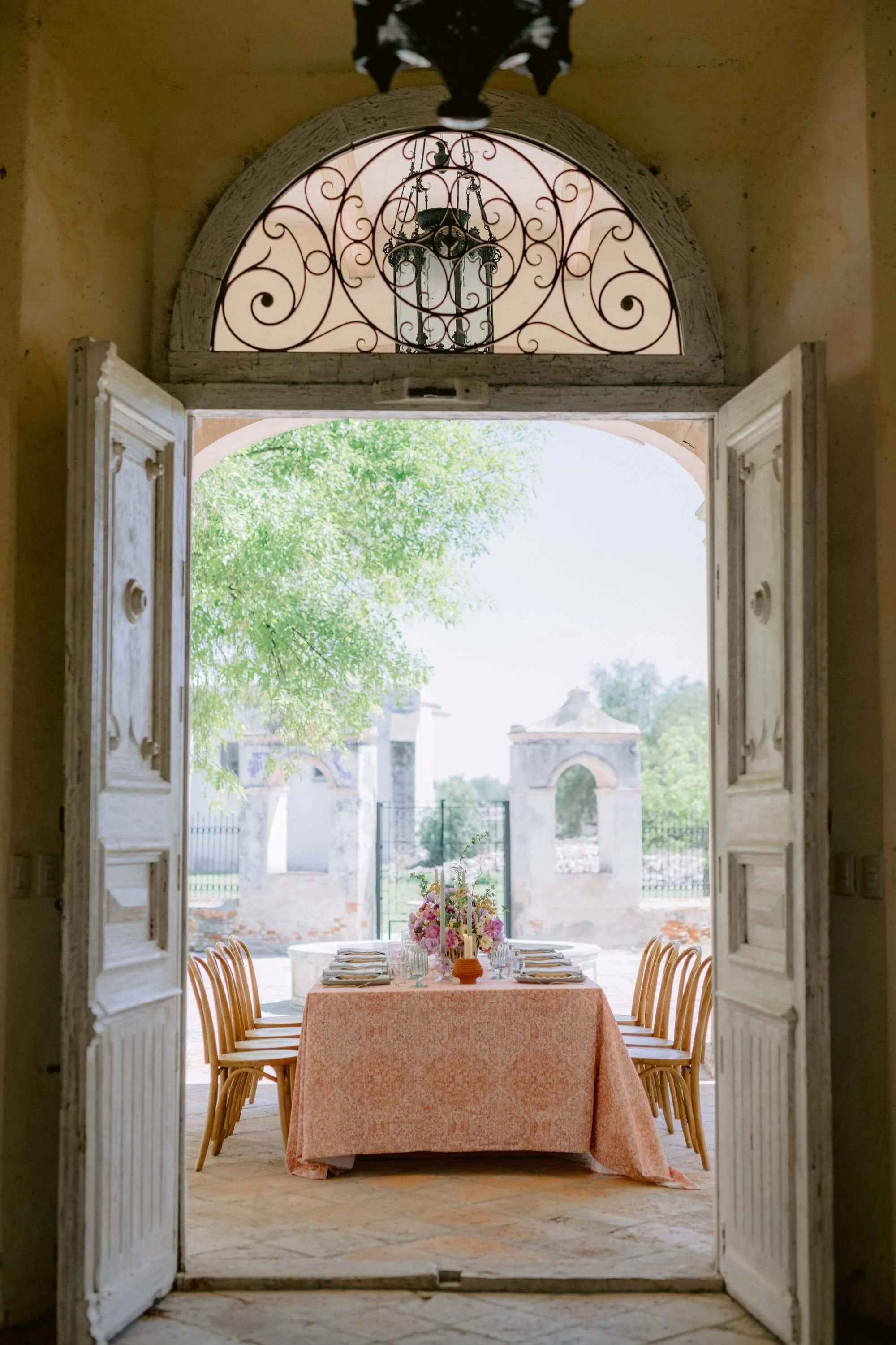 romantic destination wedding table with soft pink linens and garden-style floral centerpieces Mexico