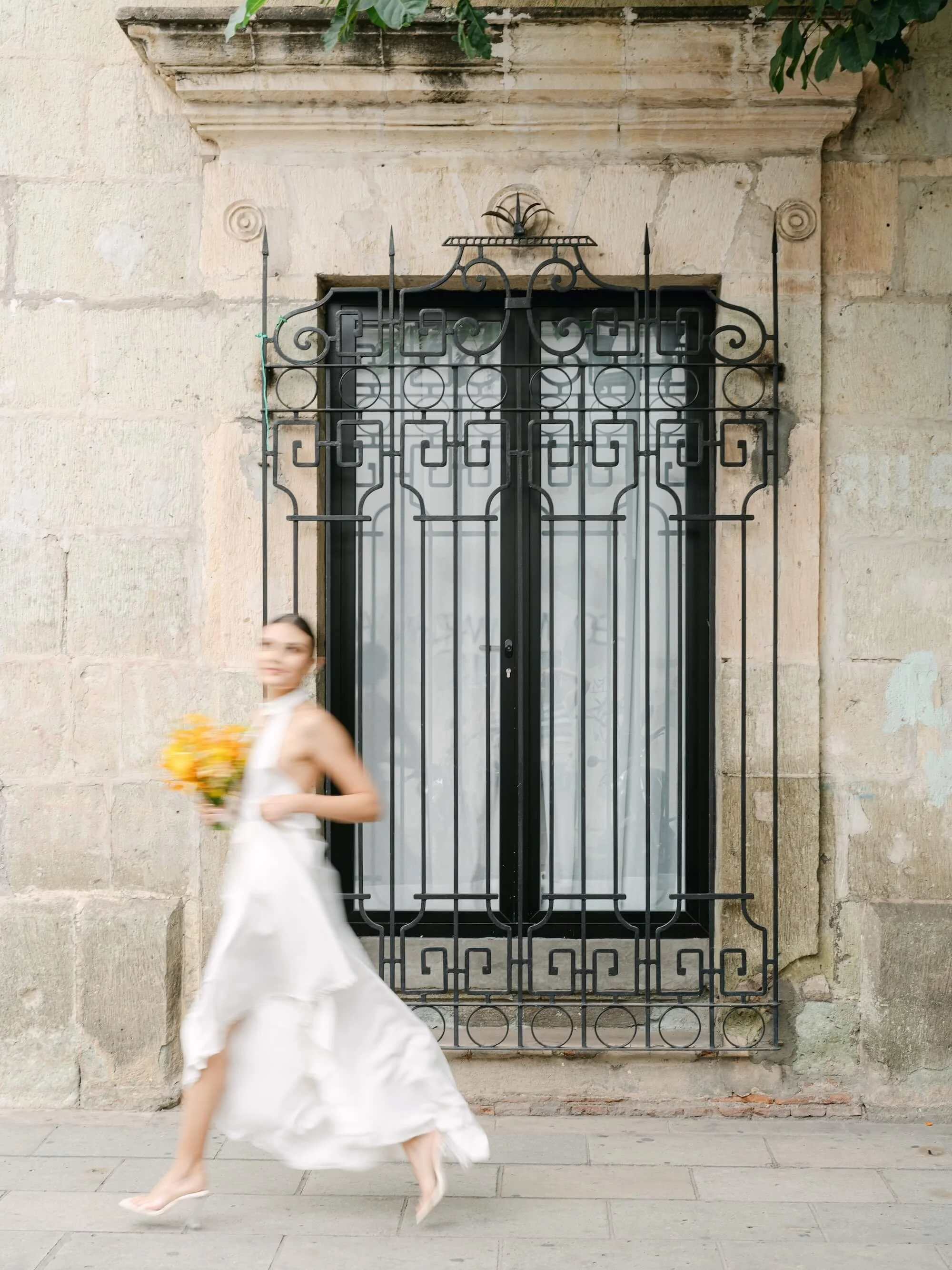 destination wedding bride with yellow floral arrangement by Florklor