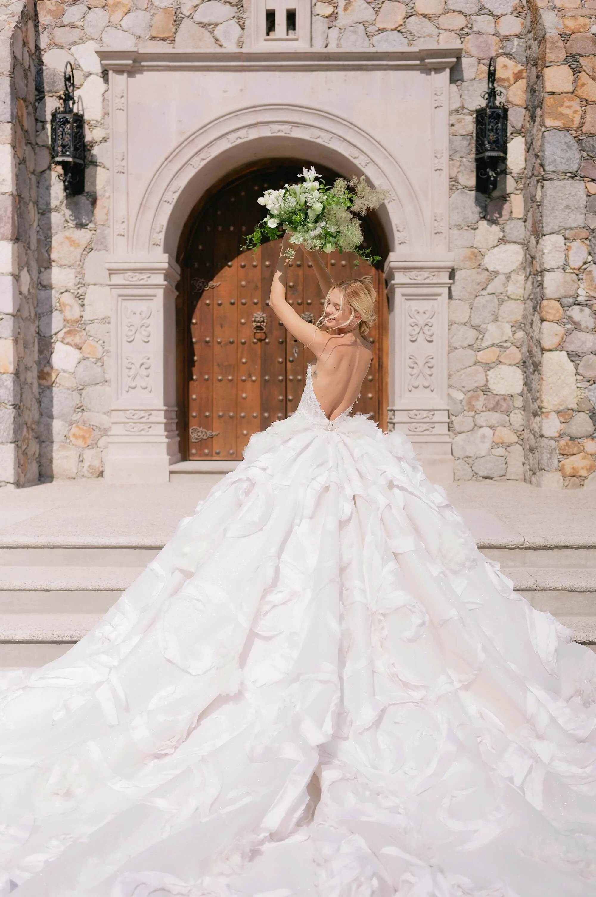 Bride in voluminous couture wedding gown holding an organic white floral bouquet at a luxury hacienda in San Miguel de Allende