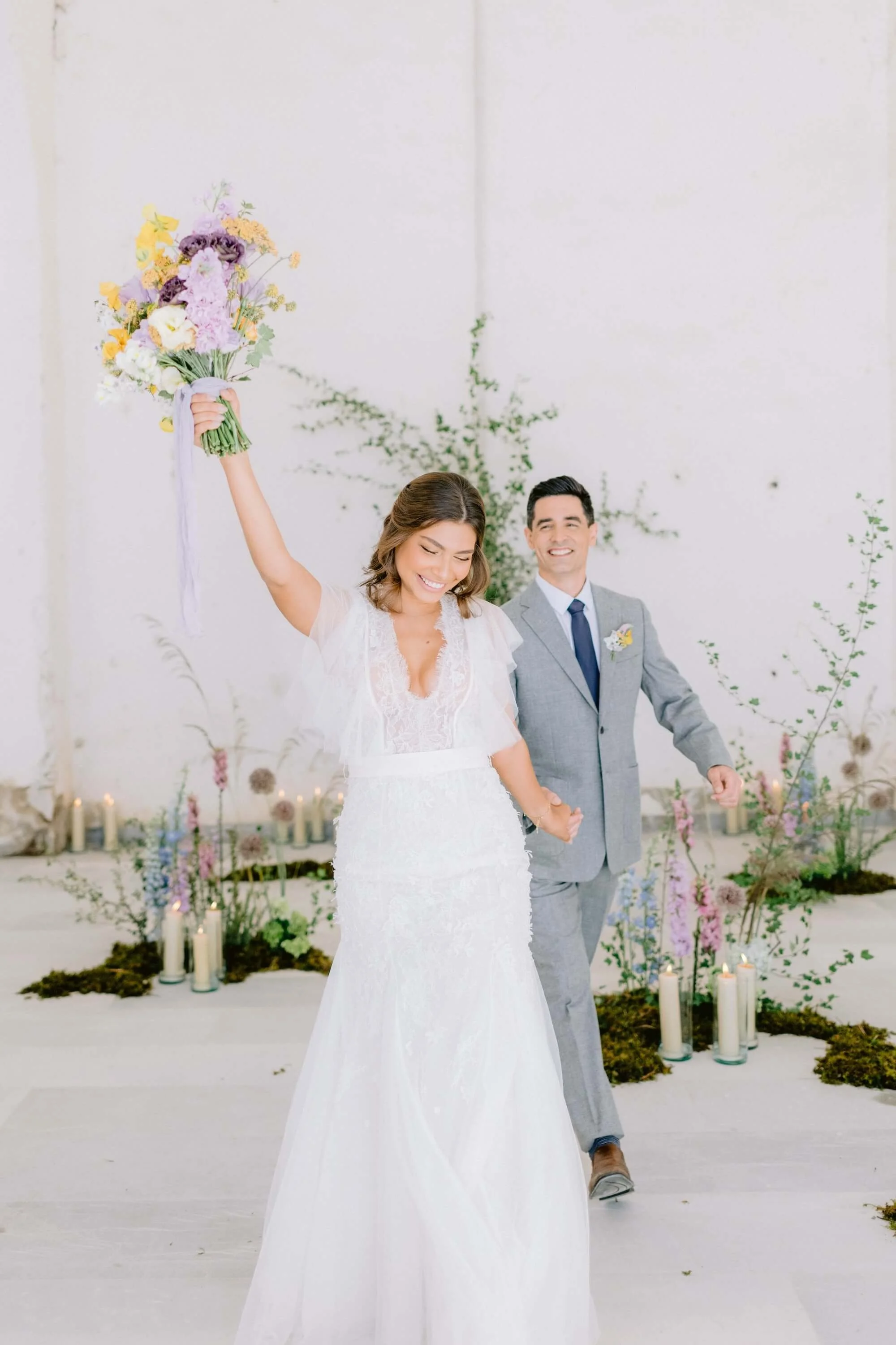 destination wedding reception with romantic floral design and architectural backdrop