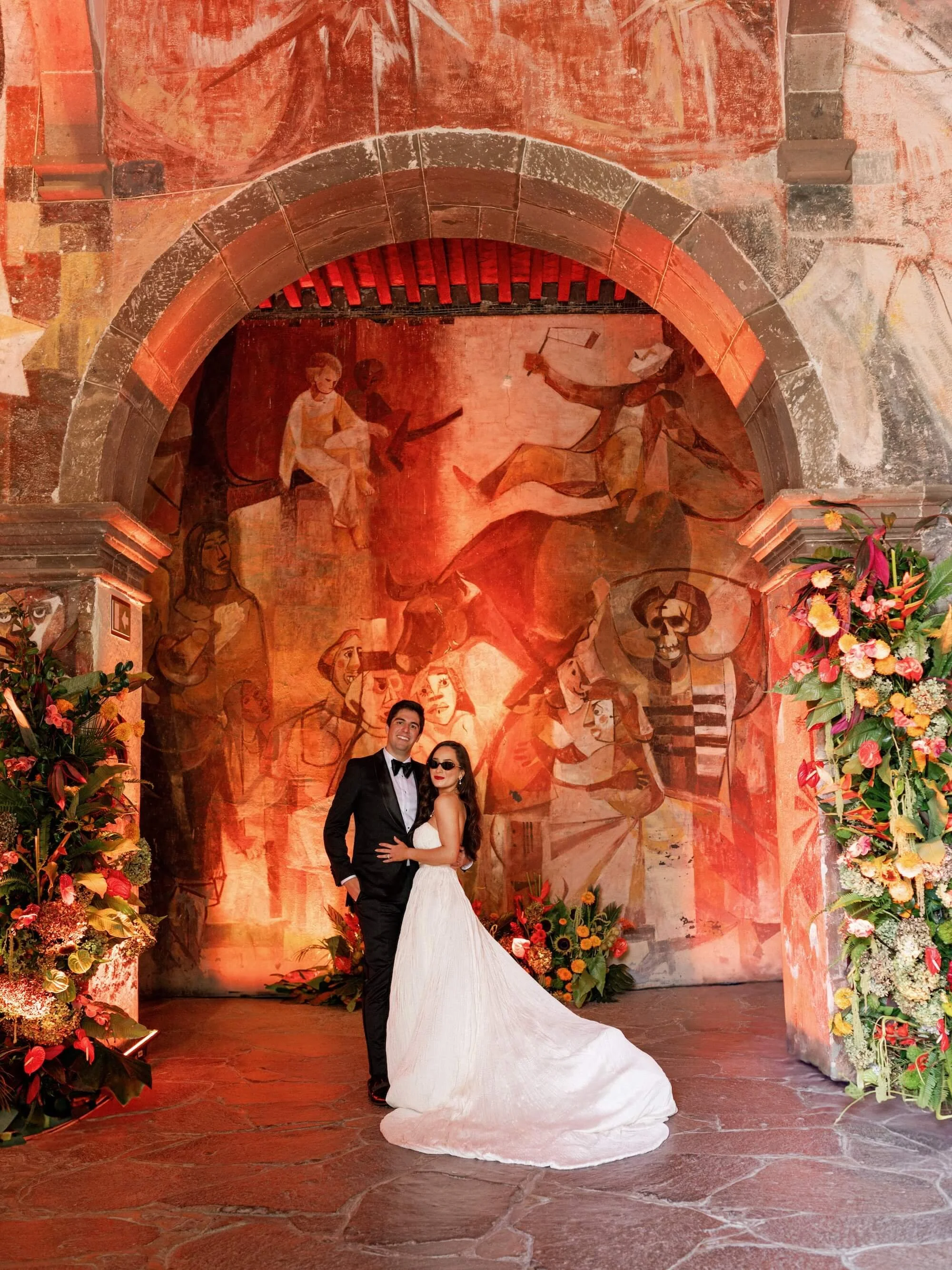 cascading floral installation framing an intimate wedding ceremony