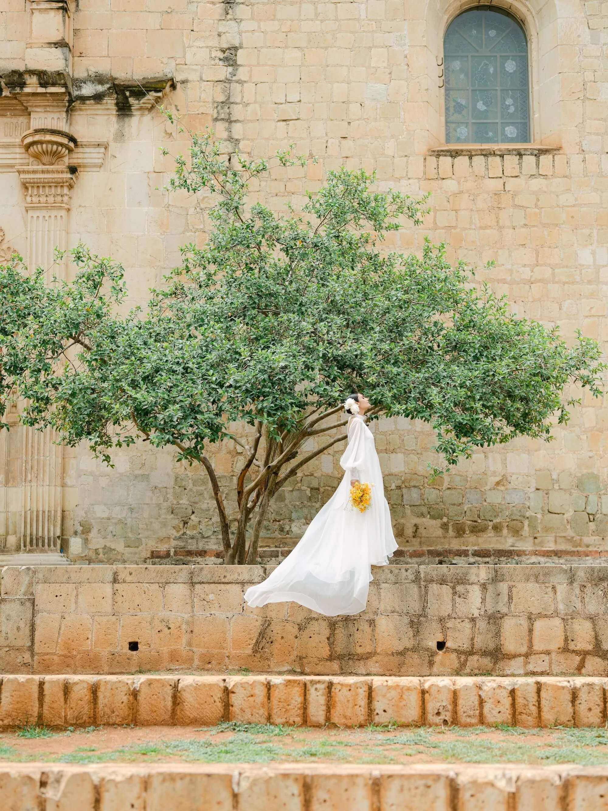 luxury wedding florist Mexico creating natural bouquet with yellow flowers
