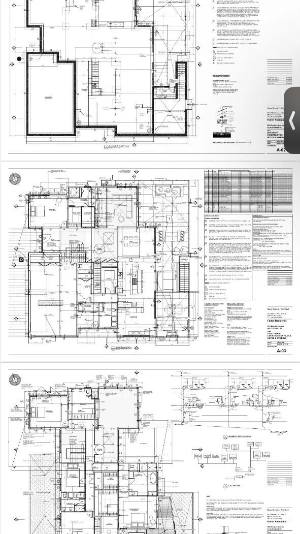 Architectural blueprints displaying detailed floor plans of a residential building, including layout, rooms, measurements, and structural elements.