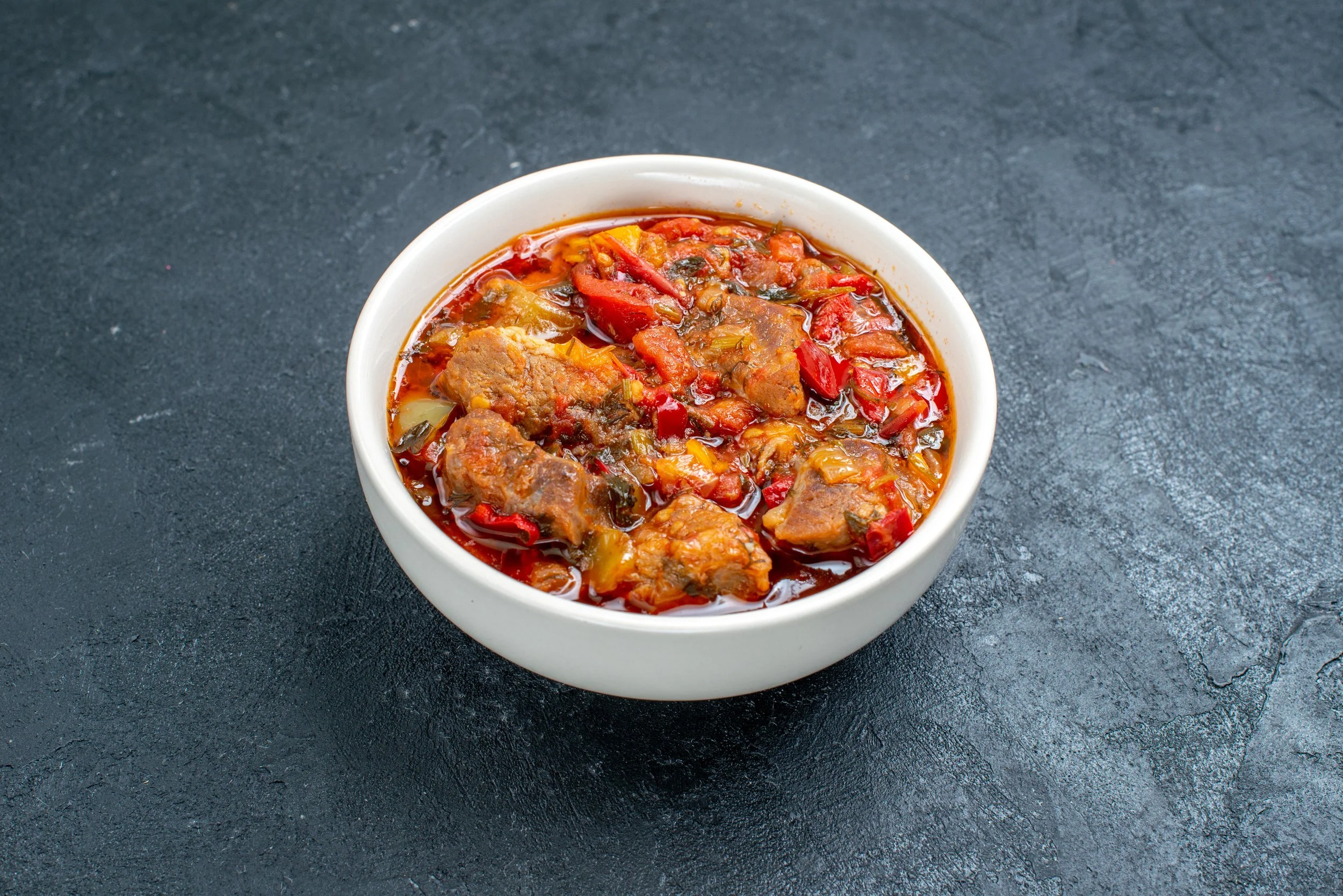 front-view-delicious-vegetable-soup-with-meat-inside-plate-grey-space.jpg