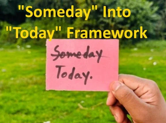 A person holding a pink paper with the words "someday" and "today" written on it written in purple ink. The background is green grass and trees.