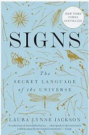 Book cover titled "Signs: The Secret Language of the Universe" by Laura Lynne Jackson, featuring illustrations of celestial and mystical symbols on a light blue background.