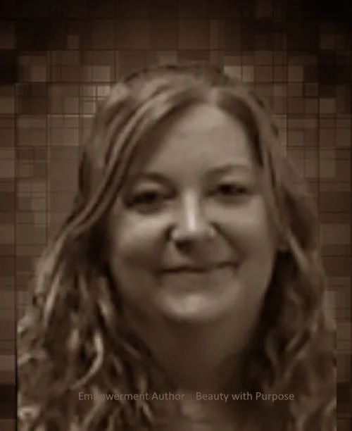 Black and white close-up photo of a woman with wavy hair smiling.