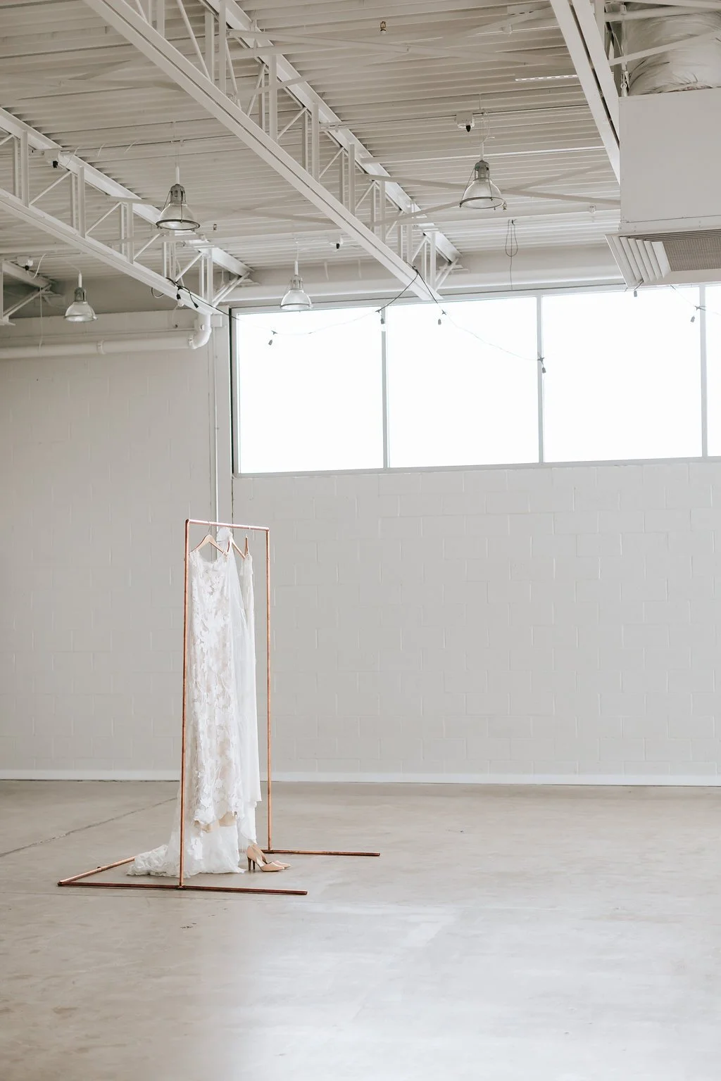 bridal gown hanging up at holden room for micro wedding