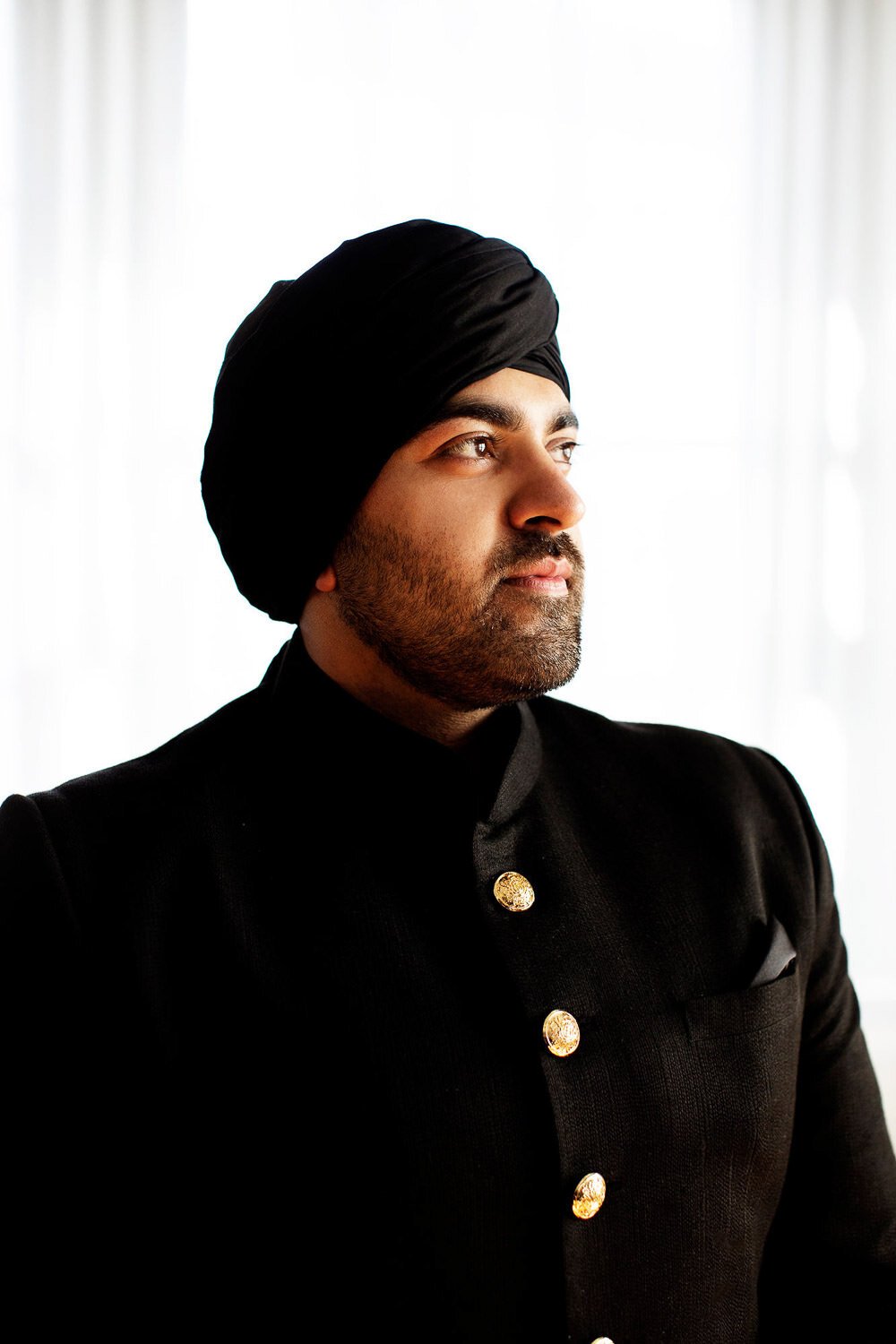 Handsome Indian groom dressed in black for his wedding - event design by Rocket Science Events, photo by Photogen Inc.