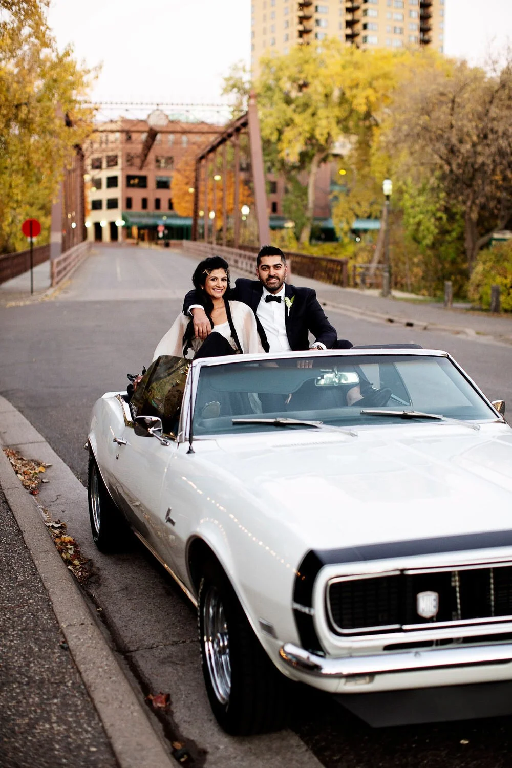 Modern Indian wedding couple in a convertible in Minneapolis, Minnesota - event design by Rocket Science Events, photo by Photogen Inc.