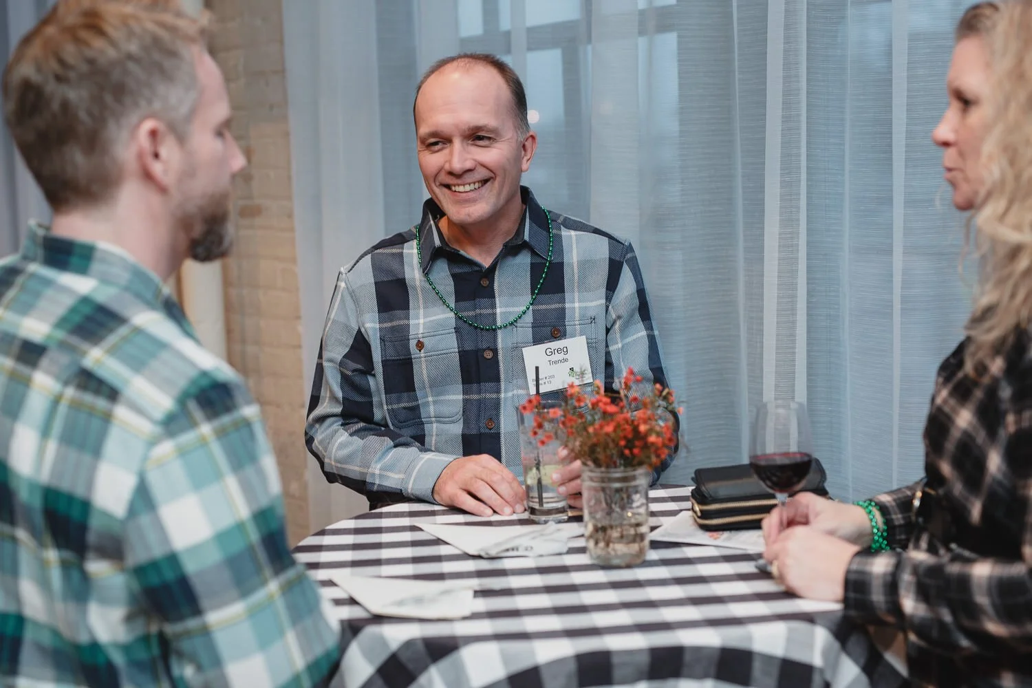 guests in flannel shirst mingle at Americana farm themed event