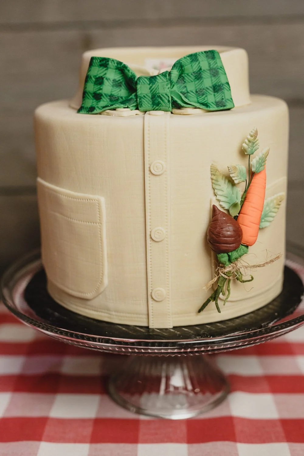 cake with fondant shaped like men’s shirt with green bow tie and carrot and beet  boutonniere
