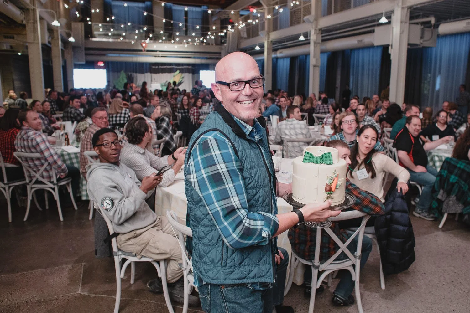 man in blue flannel shirt wins cake