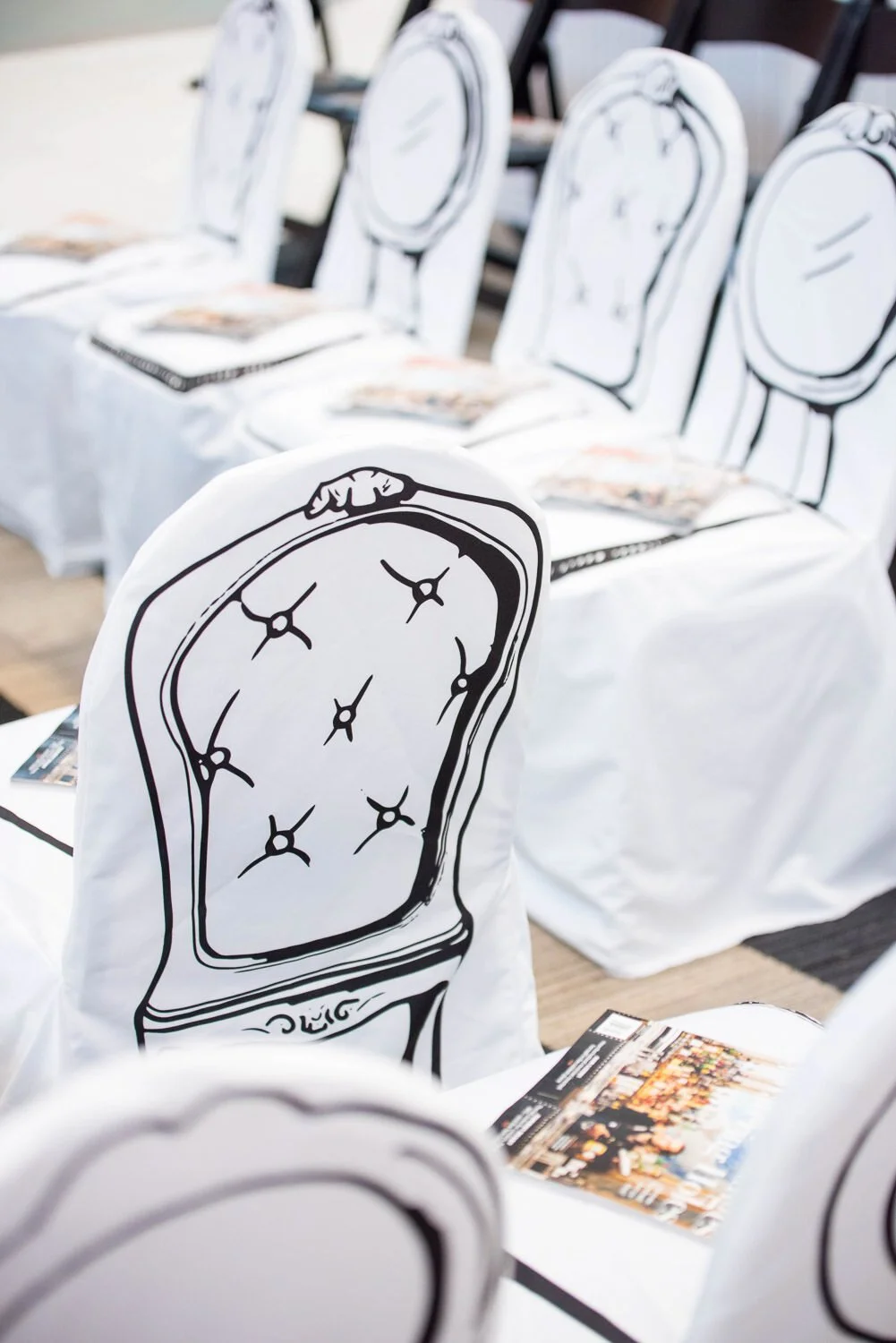 white chair covers with black chair motif