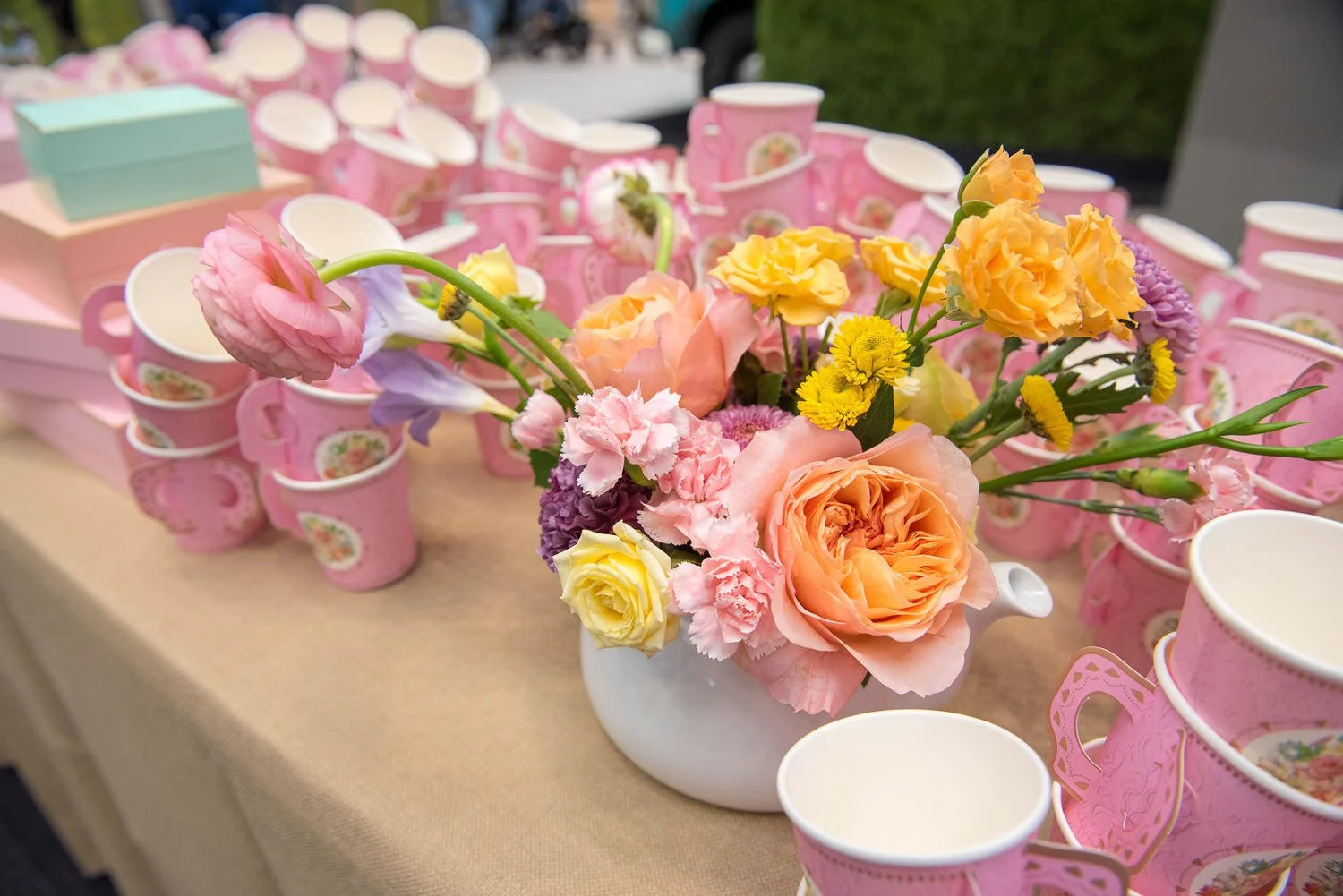 spring blooms in pink, orange, and yellow and paper cups with fine china motif