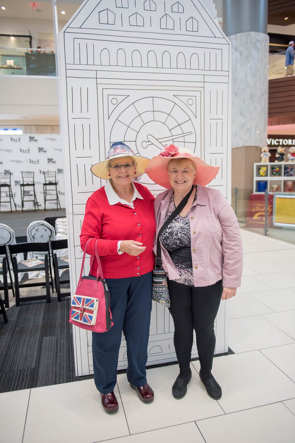 guests for British inspired fashion event in front of London motif large paper cutouts