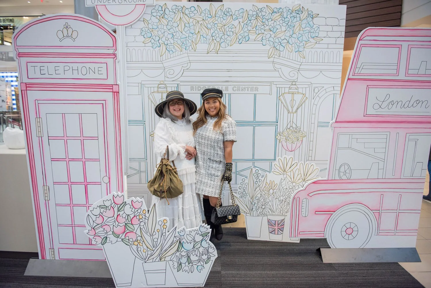 guests for British inspired fashion event in front of London motif large paper cutouts