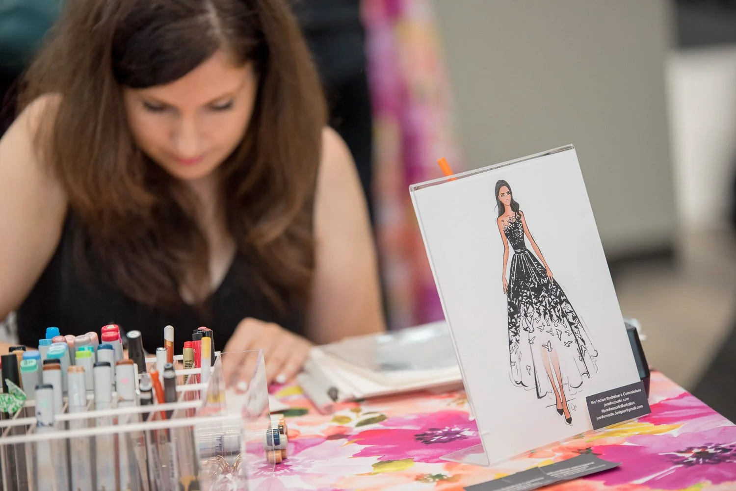 artist draws fashion sketches at British inspired fashion event