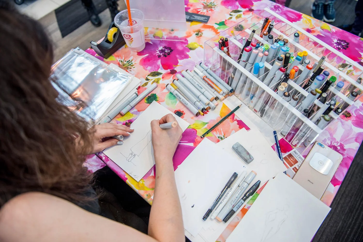 artist draws fashion sketches at British inspired fashion event