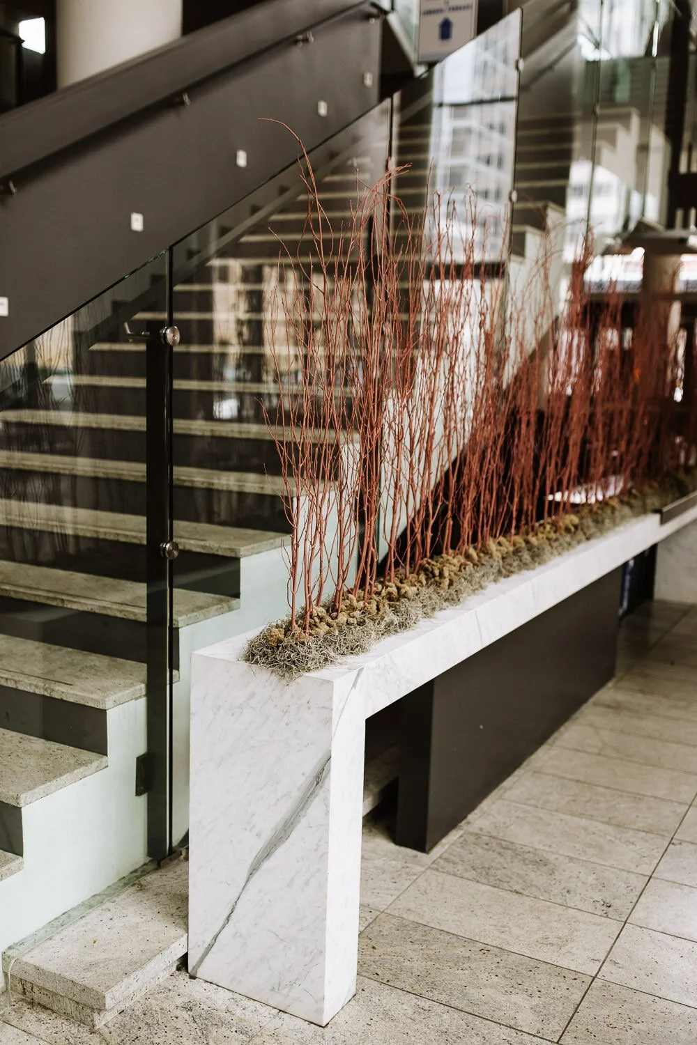 wedding reception detail of dried moss and burnt orange twigs