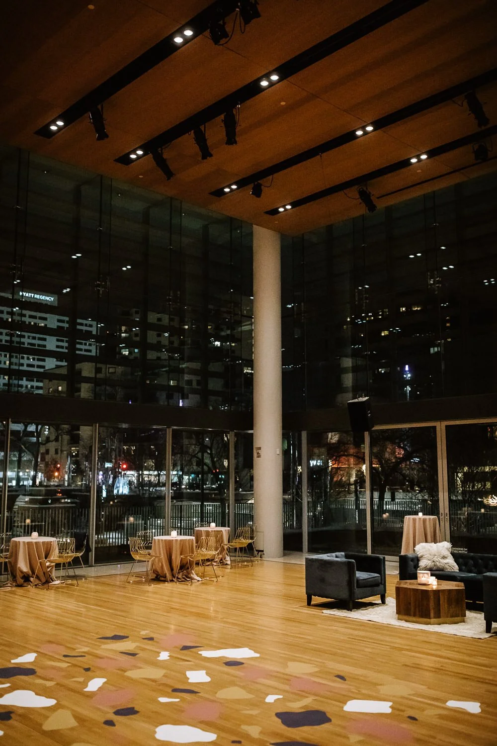 wedding reception seating area with modern lounge furniture and geometric decals on floor in dusty pink, mustard yellow, white and charcoal grey.