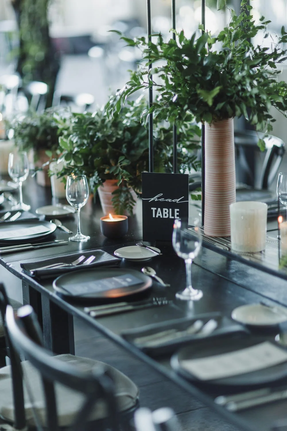 wedding reception tablescapes with black and white design and all green florals, black charger plates